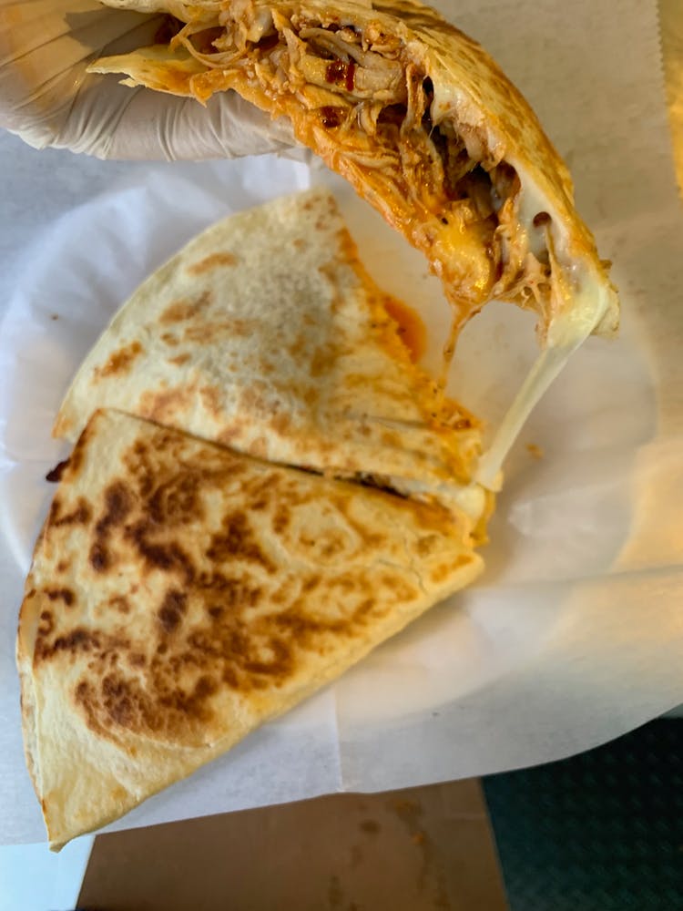 a slice of pizza on a paper plate